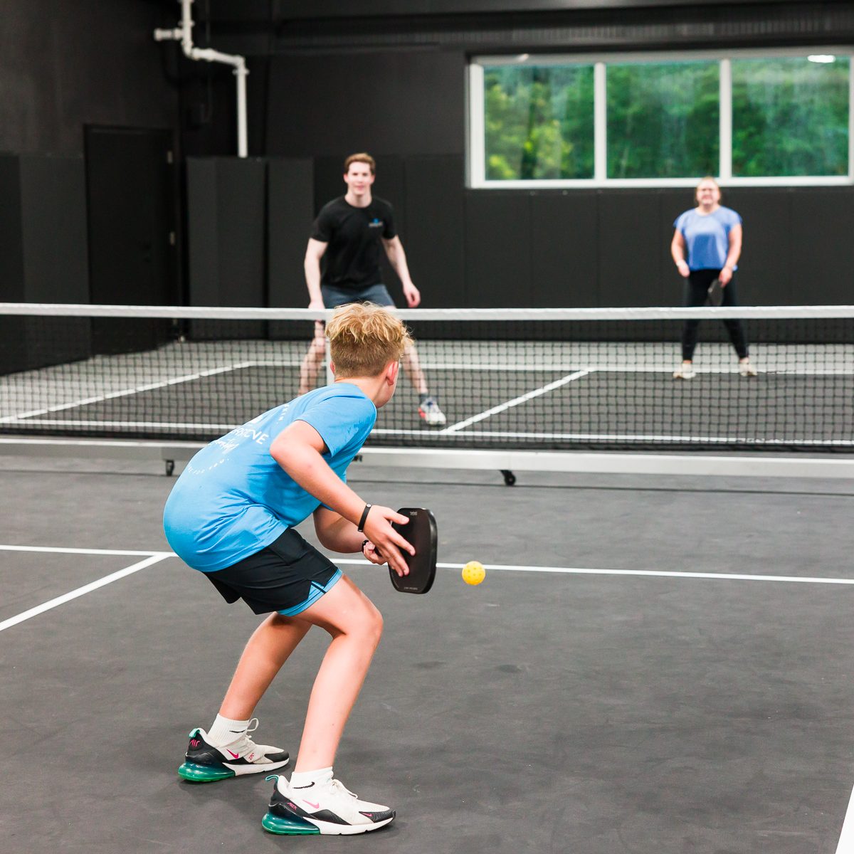Friends playing pickleball at TOPCOURT LS in Lee's Summit.