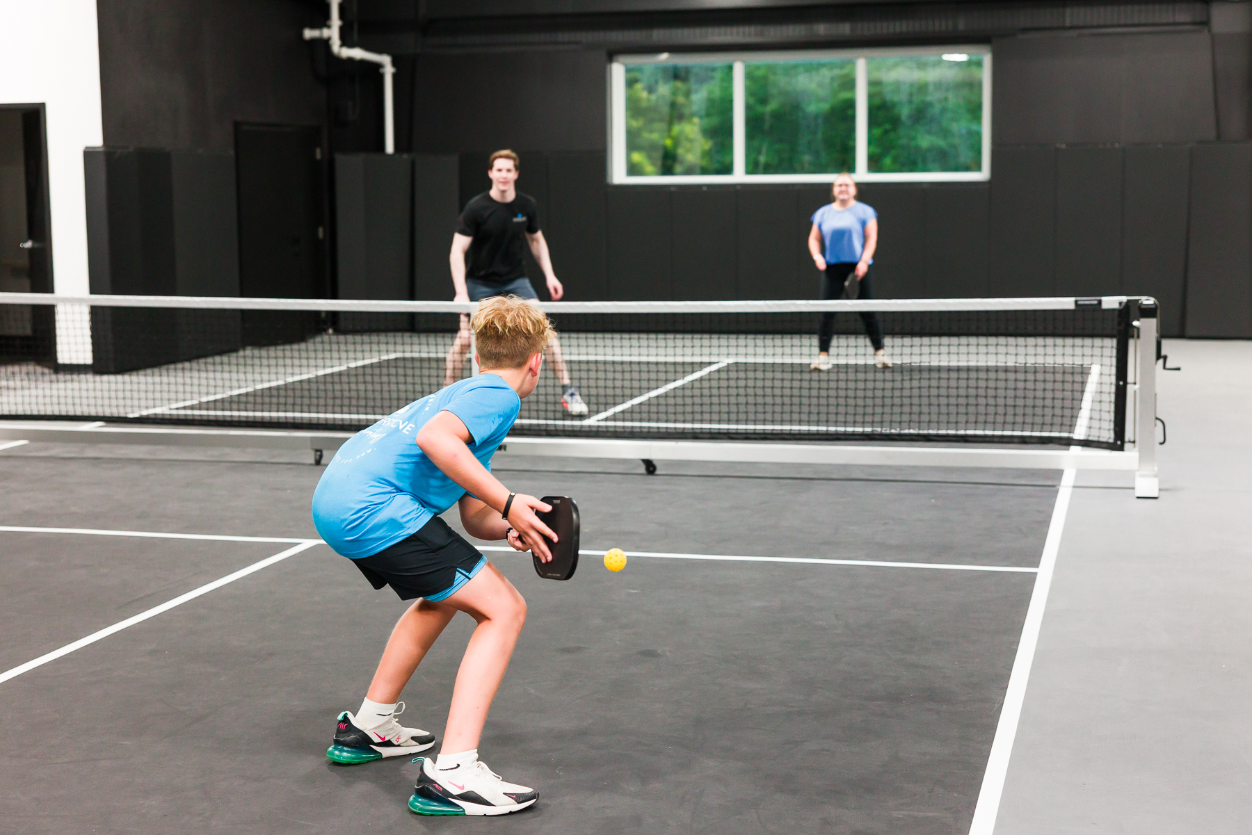 Friends playing pickleball at TOPCOURT LS in Lee's Summit.